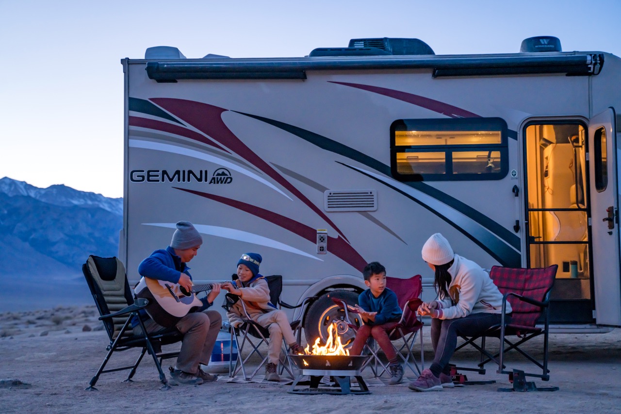 Scenic shot of an RV outdoors with family.